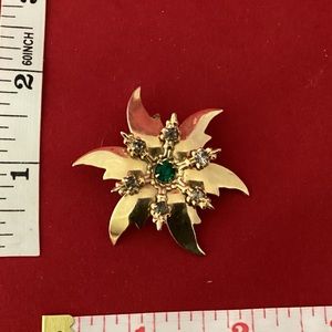Gold tone green and white poinsettia brooch